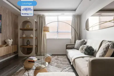 a living room with a couch and a glass table at Cozy 4-Bedrooms House By Azzurri Properties Short Lets & Serviced Accommodation London With Private Garden, Wi-Fi in Moffat