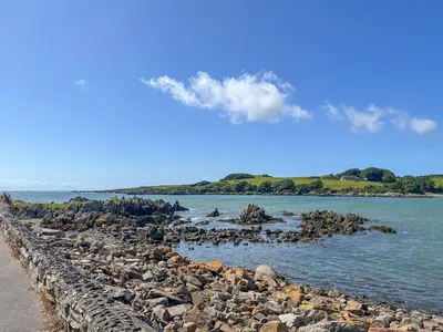 a group of rocks on the shore of a body of water at 3 Laigh Isles in Kirkcudbright