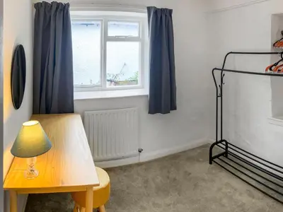 a room with a table and a window at Hideaway Cottage in Keswick