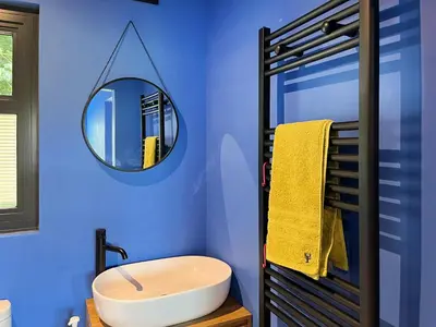 a blue bathroom with a sink and a mirror at Andromeda - Uk50359 in Castle Douglas