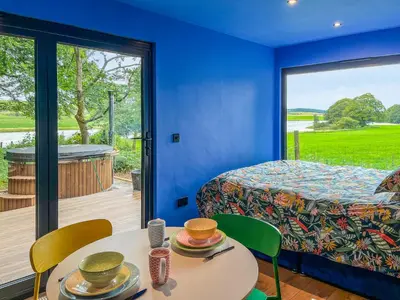 a room with a bed and a table with chairs at Andromeda - Uk50359 in Castle Douglas