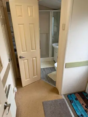an open door to a bathroom with a toilet at The West Lakes Caravan in Lamplugh