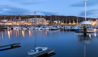 a bunch of boats in a marina at night at Birks Terrace - 2 Bedroom - Sleeps 4 in Cleator Moor