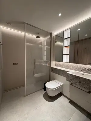 a bathroom with a toilet and a shower and a sink at Modern Serviced Apartment in Kings Cross Central London in Moffat