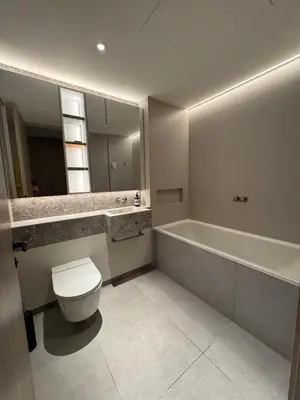 a bathroom with a tub and a toilet and a sink at Modern Serviced Apartment in Kings Cross Central London in Moffat