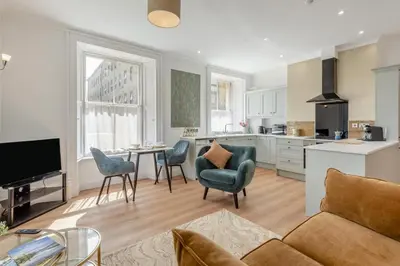 a living room with a couch and a table and chairs at 1 Bed in Cockermouth oc-h32941 in Cockermouth