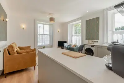 a kitchen and living room with a large white counter top at 1 Bed in Cockermouth oc-h32941 in Cockermouth