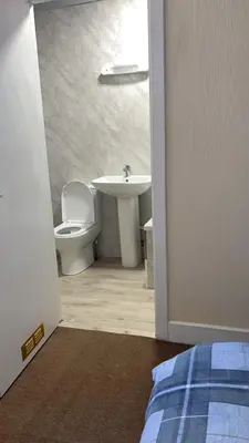 a bathroom with a toilet and a sink at QueensBerry accommodation in Annan