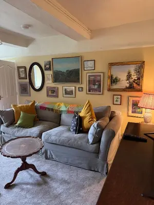 a living room with a couch and a table at 1 Laithes Cottages in Skelton
