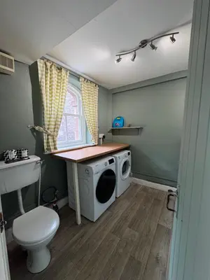 a laundry room with a washing machine and a sink at 1 Laithes Cottages in Skelton