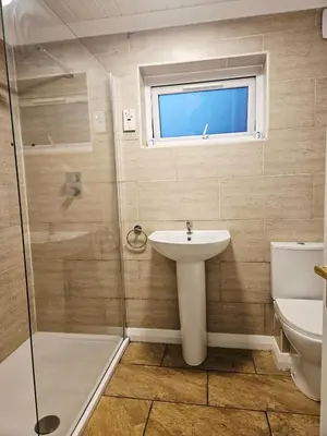 a bathroom with a sink and a shower at Egremont 2-Bed Flat Near Lake District with Free Parking & Wi-Fi in Egremont