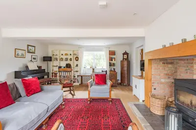 a living room with a couch and a fireplace at St Mary's House by Keepers Cottages in Moffat