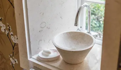 a bathroom sink with a faucet and a window at Gorgeous Georgian townhouse in Moffat