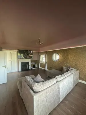 a living room with a large couch and a fireplace at Brig o Doon 3 in Ayr