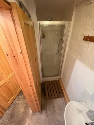 a bathroom with a shower and a toilet and a sink at Hillside Farm in Carlisle