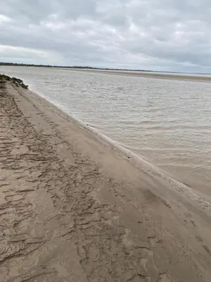 a sandy beach with a body of water at Hillside Farm in Carlisle
