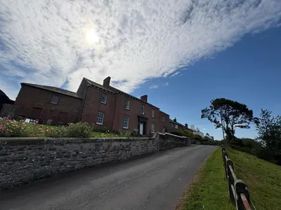 an empty road next to a brick building at Hillside Farm in Carlisle
