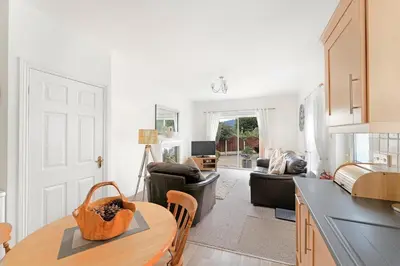 a kitchen and living room with a table and chairs at 8 Harney Peak in Portinscale