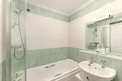 a bathroom with a sink and a toilet and a shower at 8 Harney Peak in Portinscale