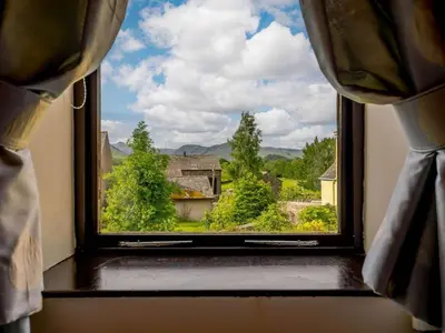 a window with a view of the countryside seen through it at 4 Bed in Cockermouth oc-sz098 in Lorton