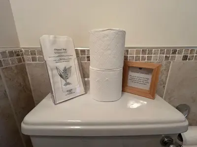 a roll of toilet paper sitting on top of a toilet at Hollyside Lodge in Carlisle