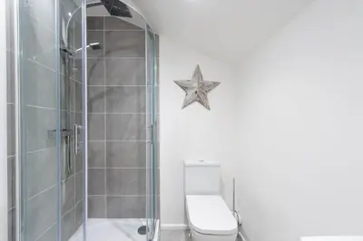 a bathroom with a shower and a toilet at 5 Bed Workington House with Parking Near Station in Workington