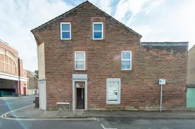 a brick building on a city street at 5 Bed Workington House with Parking Near Station in Workington