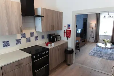 a kitchen with a sink and a stove top oven at Cosy 1-Bedroom Flat, Walk to Beaches in Troon