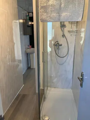 a shower with a glass door in a bathroom at Blackpool chalet - free parking in Moffat