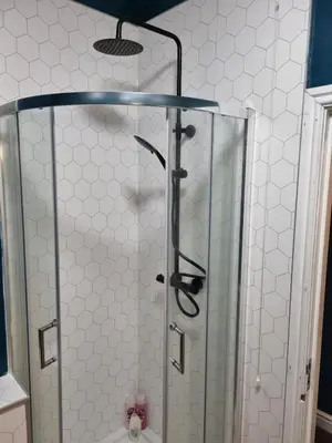 a shower with a glass door in a bathroom at No3 Spacious Apartment Cockermouth in Cockermouth