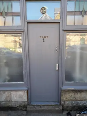 a white door with the word fat written on it at Studio No1, Cockermouth, The Lakes in Cockermouth