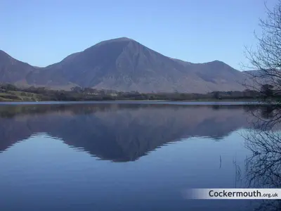 a mountain reflection in a lake with a mountain in the background at Studio No5, Cockermouth The Lakes in Cockermouth