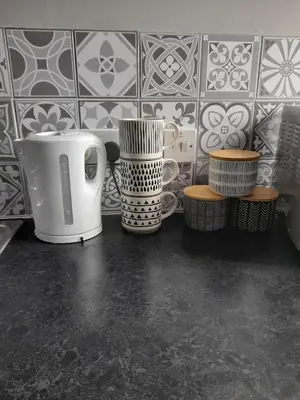 a kitchen counter with cups and plates on a wall at Studio No5, Cockermouth The Lakes in Cockermouth