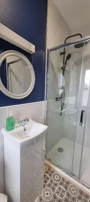 a bathroom with a shower and a sink and a mirror at Studio No5, Cockermouth The Lakes in Cockermouth