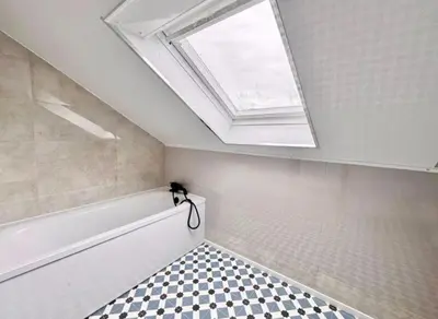 a skylight in a bathroom with a bath tub and a shower at Central Charming Sea View Loft Flat in Troon