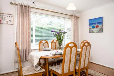 a dining room with a table and chairs and a window at 70 Abbotsbury Road, Bury St Edmunds, IP33 2HP in Moffat