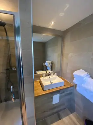 a bathroom with a sink and a mirror at The Little Inn at Grasmere in Grasmere
