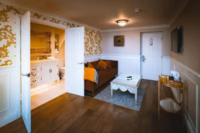 a living room with a couch and a table at The Little Inn at Grasmere in Grasmere