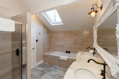 a bathroom with a sink and a bath tub at The Little Inn at Grasmere in Grasmere