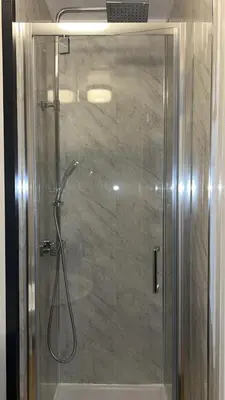 a shower with a glass door in a bathroom at QueensBerry Annan in Annan