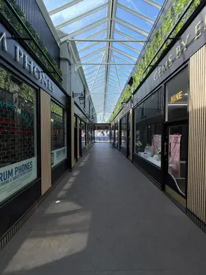 a walkway in a shopping mall with glass ceilings at 3 bedroom traditional apartment in Ayr