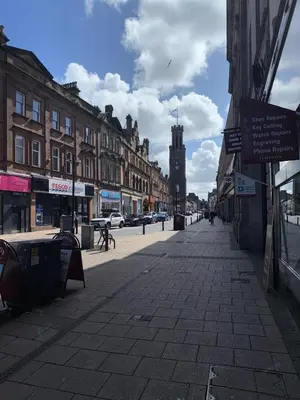 an empty city street with buildings and a clock tower at 3 bedroom traditional apartment in Ayr
