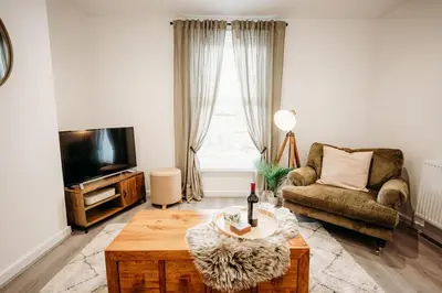a living room with a couch and a tv at 4 Bed Sheffield home in Moffat
