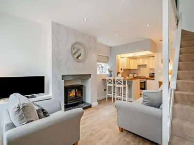 a living room with two chairs and a fireplace at 1 Bed in Keswick 96314 in Keswick