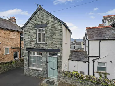 a stone house with a green door in a street at 1 Bed in Keswick 96314 in Keswick