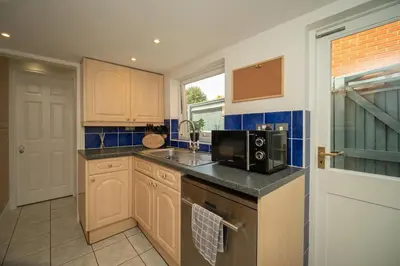 a kitchen with a sink and a microwave at Spacious 3 Bedroom home in Ascot, Sleeps 5, Parking in Moffat