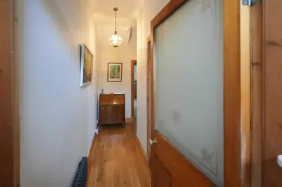 a hallway with a door and a dresser in a room at Seabreeze in Prestwick in Prestwick