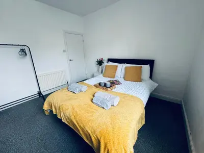 a bedroom with a bed with towels on it at Holly Terrace - 2 Bedrooms - Sleeps 3 in Whitehaven