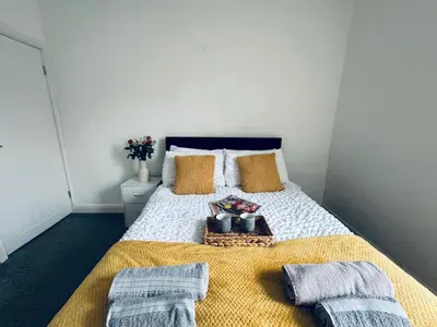 a bedroom with a bed with two towels on it at Holly Terrace - 2 Bedrooms - Sleeps 3 in Whitehaven