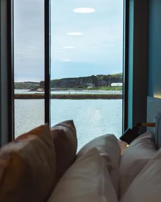 a couch in front of a window looking out at the water at The Edge in Whitehaven
